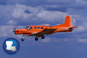 a red turboprop aircraft flying in a blue sky with cumulus clouds - with Louisiana icon