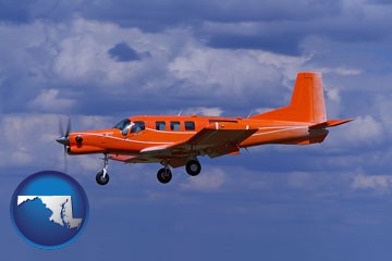 a red turboprop aircraft flying in a blue sky with cumulus clouds - with Maryland icon