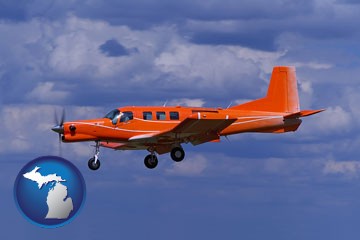 a red turboprop aircraft flying in a blue sky with cumulus clouds - with Michigan icon