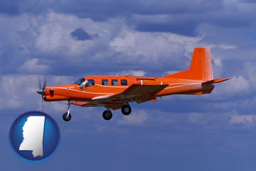 a red turboprop aircraft flying in a blue sky with cumulus clouds - with Mississippi icon