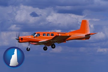 a red turboprop aircraft flying in a blue sky with cumulus clouds - with New Hampshire icon