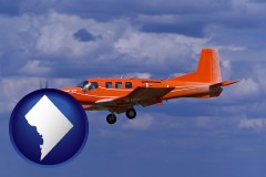 washington-dc map icon and a red turboprop aircraft flying in a blue sky with cumulus clouds