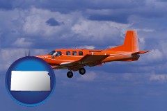 kansas map icon and a red turboprop aircraft flying in a blue sky with cumulus clouds