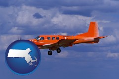 massachusetts map icon and a red turboprop aircraft flying in a blue sky with cumulus clouds