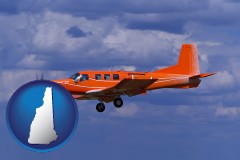new-hampshire map icon and a red turboprop aircraft flying in a blue sky with cumulus clouds