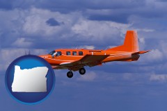 oregon map icon and a red turboprop aircraft flying in a blue sky with cumulus clouds