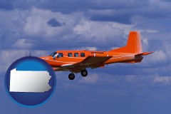 pennsylvania map icon and a red turboprop aircraft flying in a blue sky with cumulus clouds