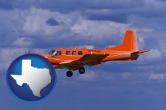 texas map icon and a red turboprop aircraft flying in a blue sky with cumulus clouds
